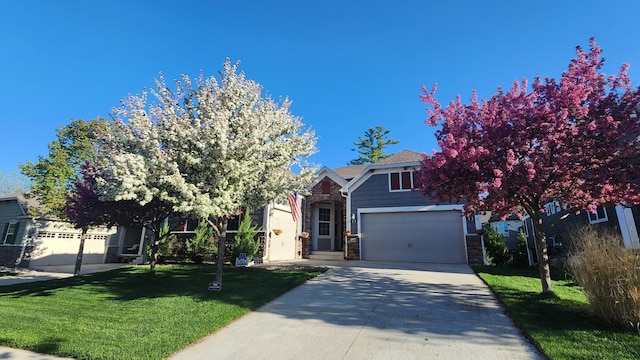 obstructed view of property featuring a garage, stone siding, a front lawn, and concrete driveway