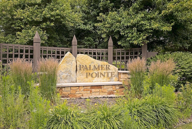 community / neighborhood sign with fence