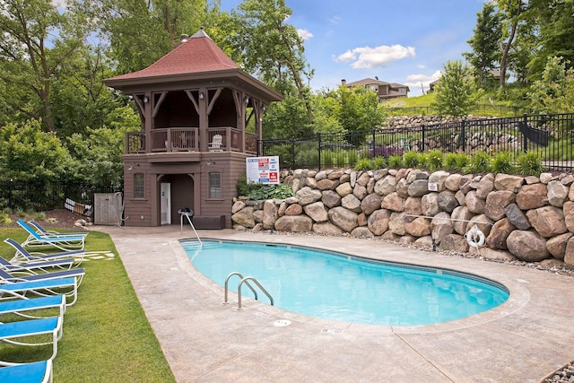 community pool featuring a patio area and fence