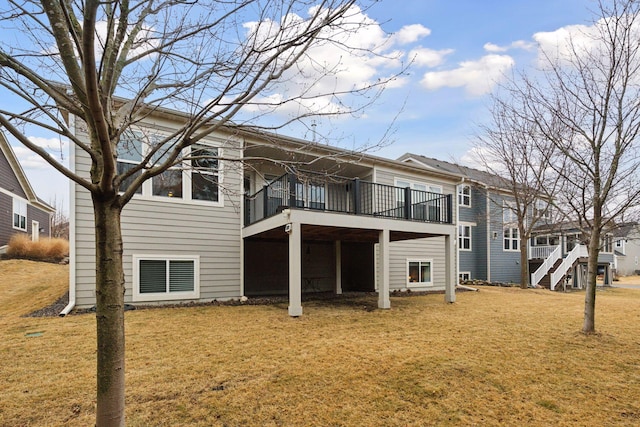 rear view of property with a yard and a deck