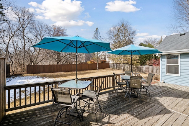 wooden deck with outdoor dining space and fence