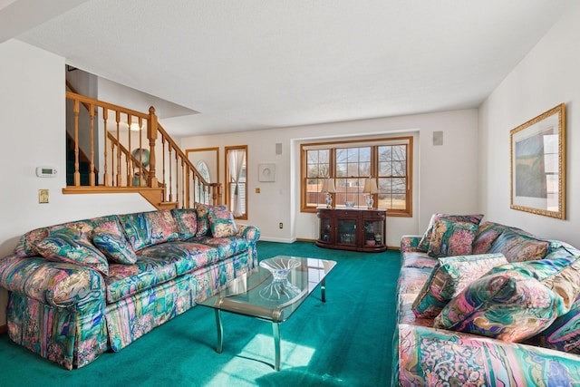 carpeted living area with stairway and baseboards