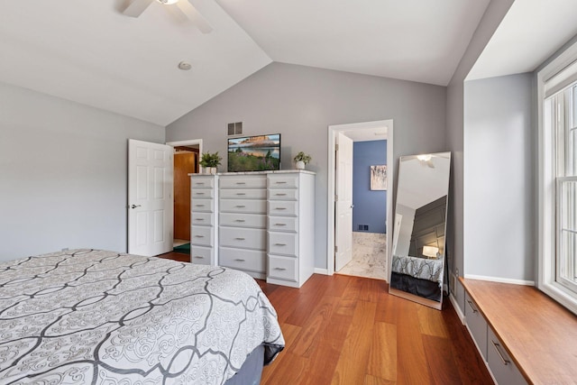 bedroom featuring vaulted ceiling, visible vents, a ceiling fan, and wood finished floors