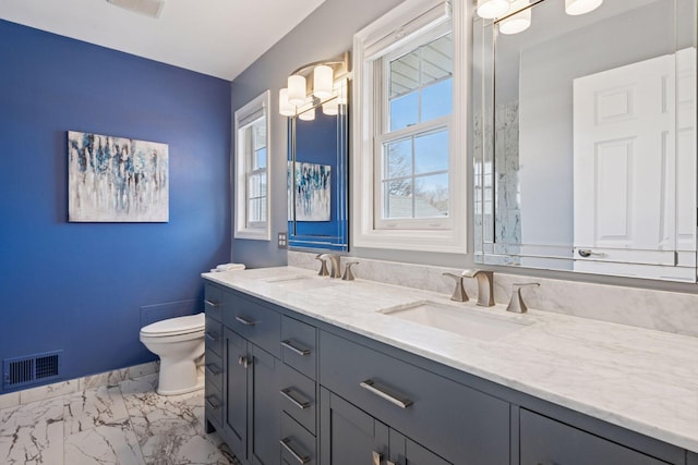 bathroom with toilet, visible vents, marble finish floor, and a sink