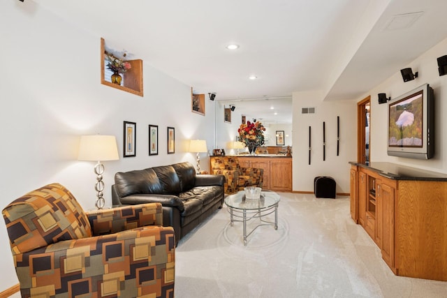 living room featuring recessed lighting, visible vents, baseboards, and light colored carpet