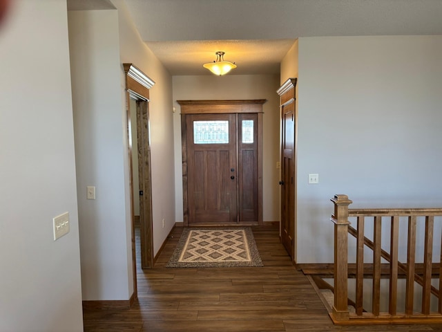 doorway to outside with baseboards and wood finished floors