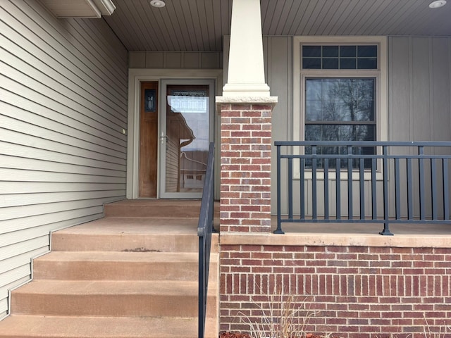 doorway to property featuring brick siding