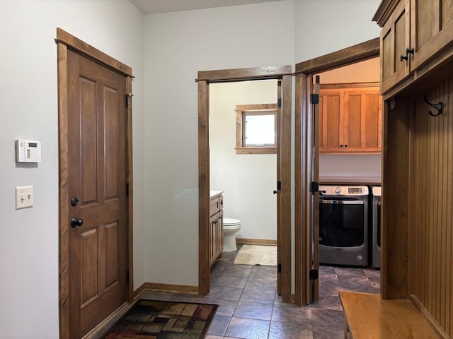 bathroom with toilet, baseboards, and vanity