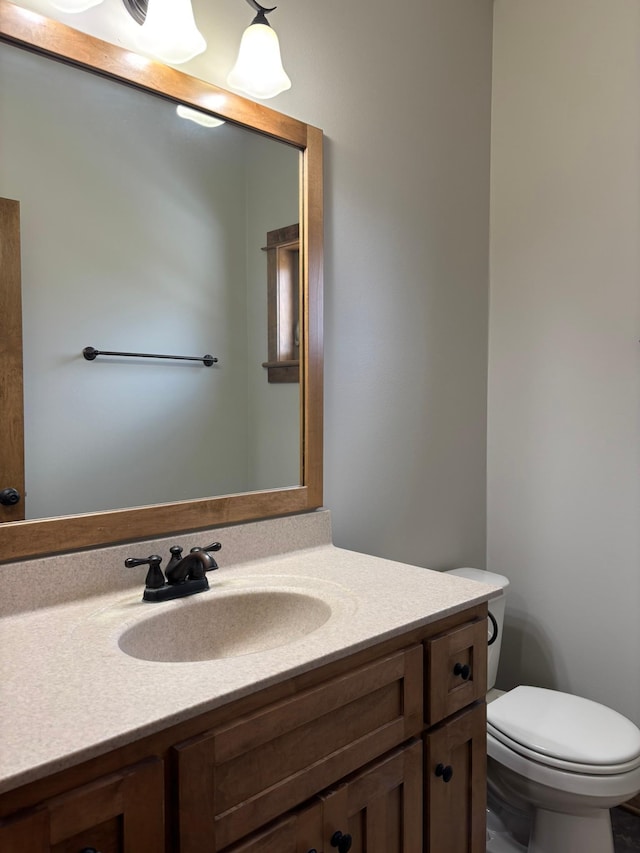 bathroom with toilet and vanity