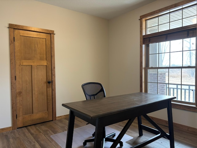 office space with baseboards and dark wood-type flooring