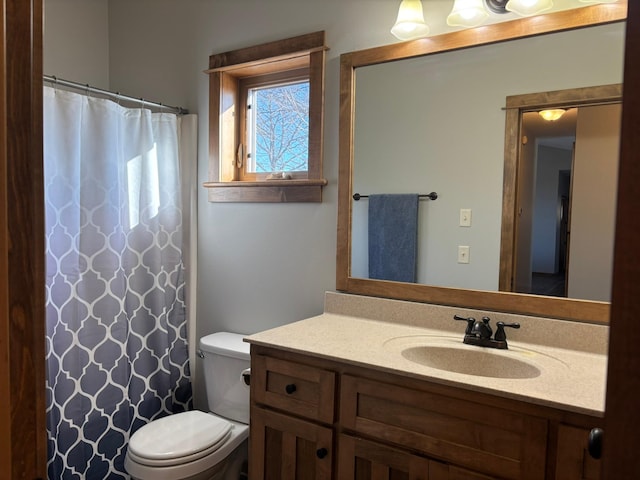 full bath featuring toilet, a shower with shower curtain, and vanity