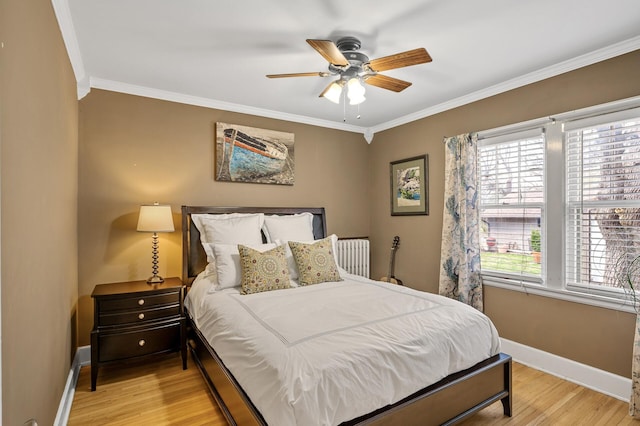 bedroom with baseboards, ceiling fan, light wood finished floors, and crown molding