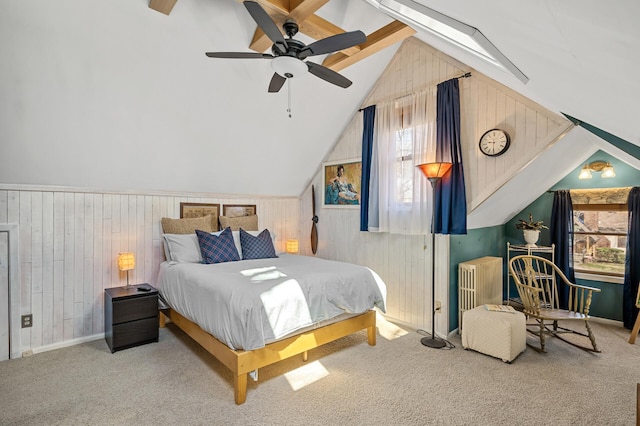 bedroom with lofted ceiling, wooden walls, carpet, and baseboards