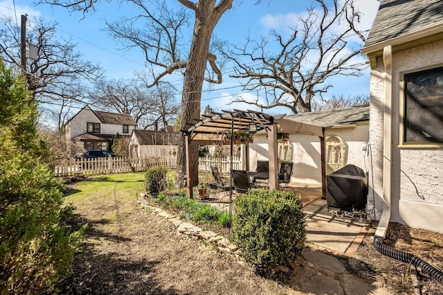 view of yard featuring fence, a pergola, and a patio