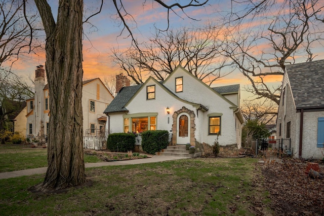 view of front of home featuring a yard and fence
