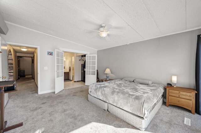 carpeted bedroom with ceiling fan, a textured ceiling, crown molding, and french doors