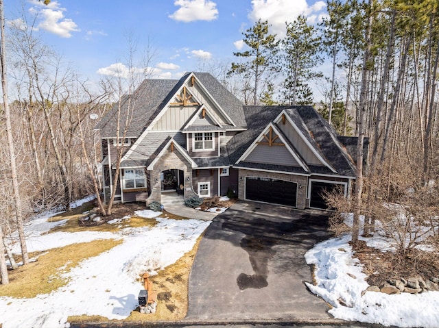 view of front of property with aphalt driveway, a garage, and board and batten siding