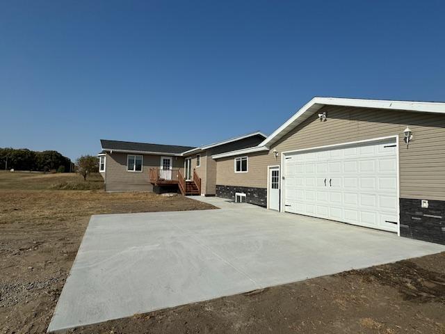 single story home with a garage and concrete driveway