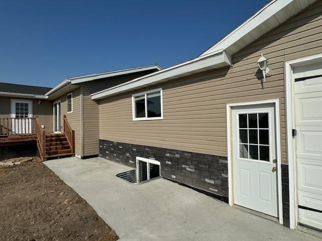 exterior space with a garage and a wooden deck