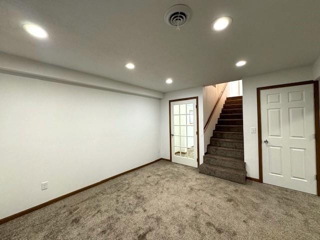 basement featuring baseboards, visible vents, stairway, carpet flooring, and recessed lighting