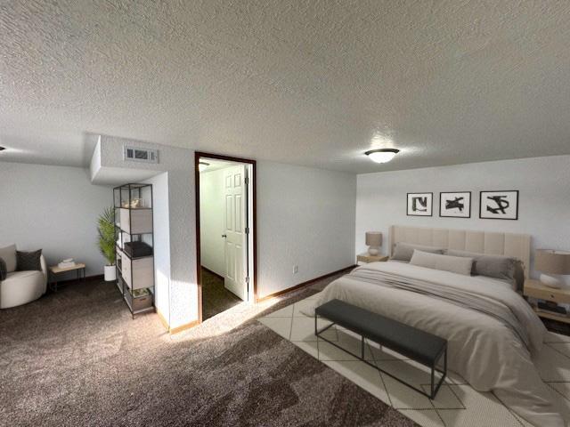 carpeted bedroom with visible vents and a textured ceiling