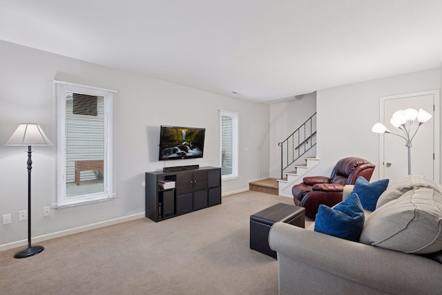 living room with carpet floors, baseboards, and stairs