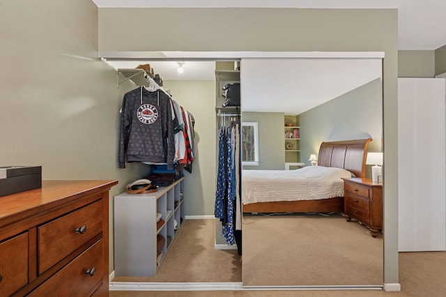 bedroom with light carpet and baseboards