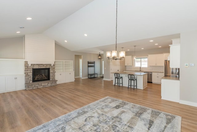 unfurnished living room with recessed lighting, light wood-style floors, and baseboards