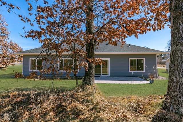 rear view of property featuring a yard and a patio