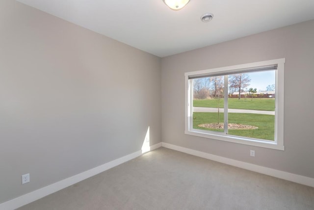 unfurnished room with light carpet and baseboards