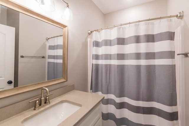 full bathroom with curtained shower and vanity