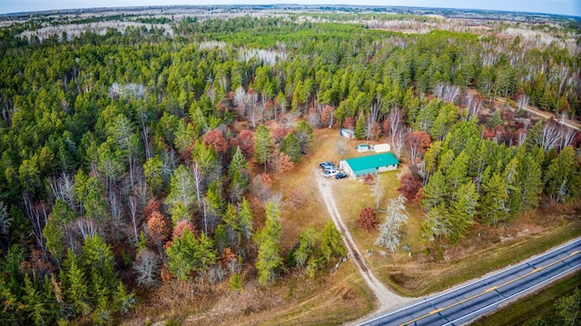 bird's eye view with a wooded view