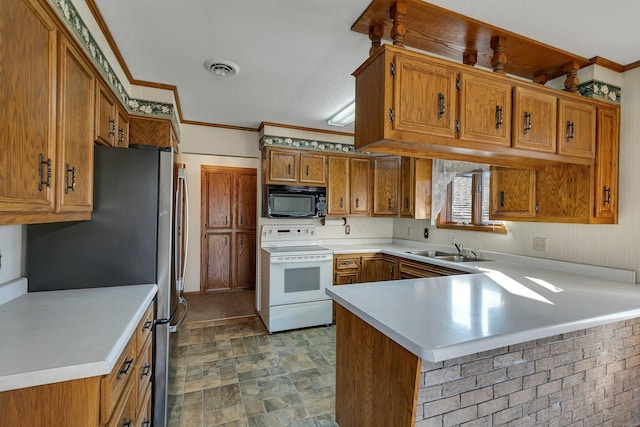 kitchen with brown cabinets, white electric stove, a sink, black microwave, and a peninsula