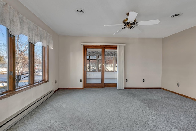 unfurnished room featuring a wealth of natural light, a baseboard radiator, visible vents, and carpet