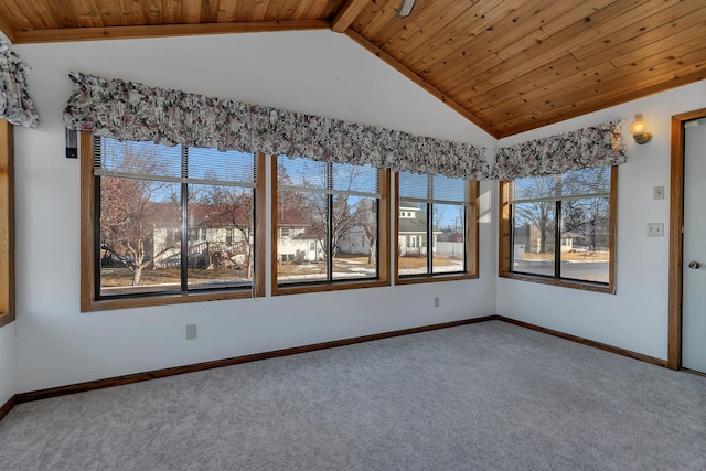 empty room with lofted ceiling, wooden ceiling, carpet flooring, and baseboards