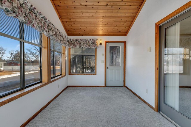 unfurnished sunroom featuring wood ceiling and vaulted ceiling