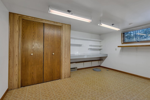 interior space featuring baseboard heating, baseboards, and tile patterned floors