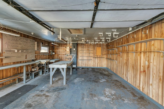 garage with wood walls and a workshop area