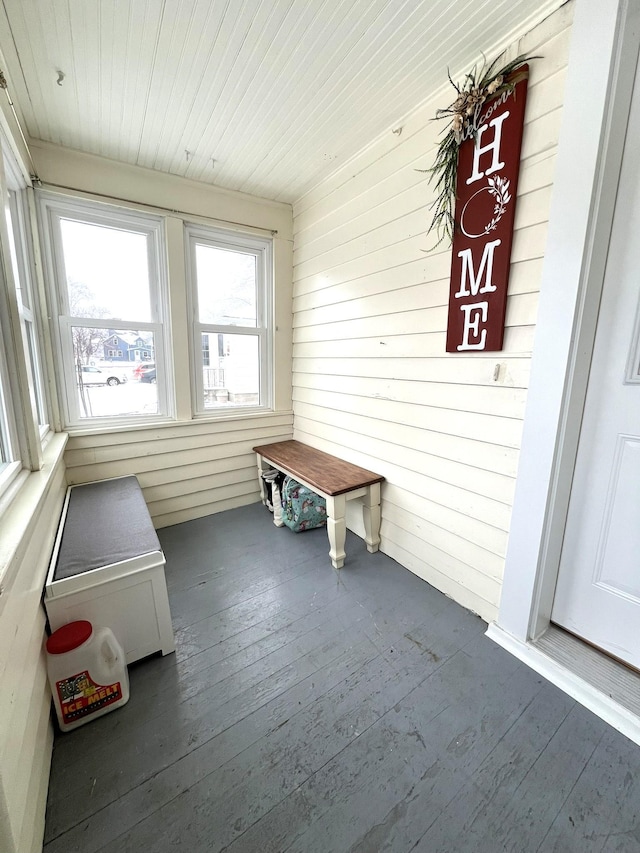 unfurnished sunroom with wooden ceiling