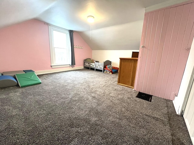 additional living space with carpet floors, lofted ceiling, and baseboards