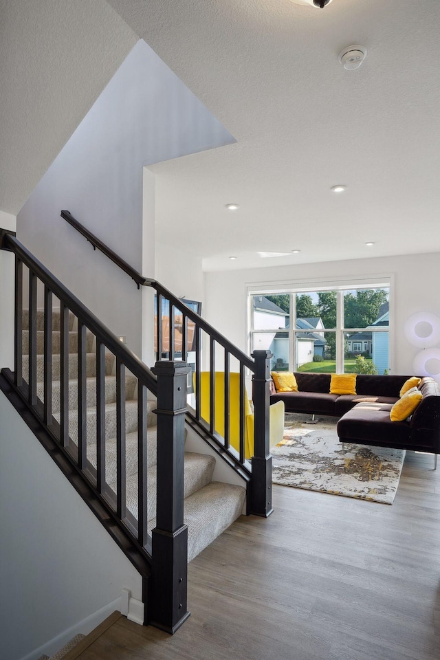 stairway featuring wood finished floors and baseboards