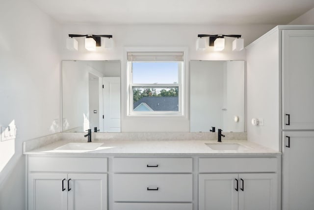 bathroom featuring double vanity and a sink