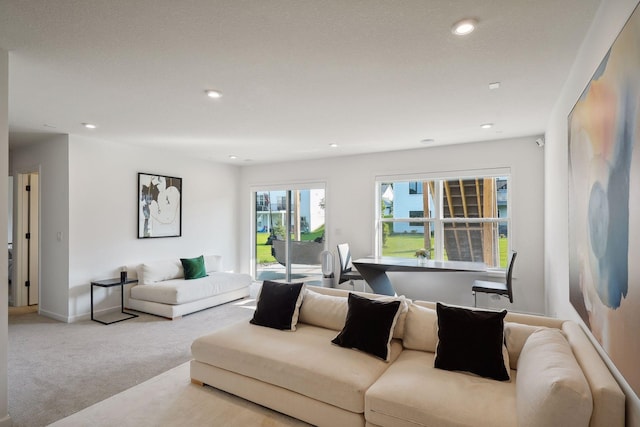 living room with baseboards, carpet floors, and recessed lighting