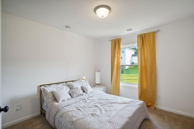 bedroom featuring carpet flooring and baseboards