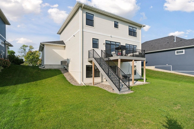 back of house featuring stairs, a yard, a deck, and central AC unit