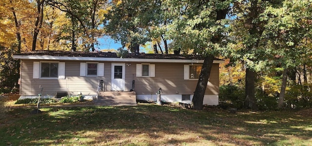 back of property featuring a lawn