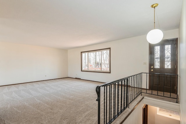 stairs featuring a wealth of natural light and carpet