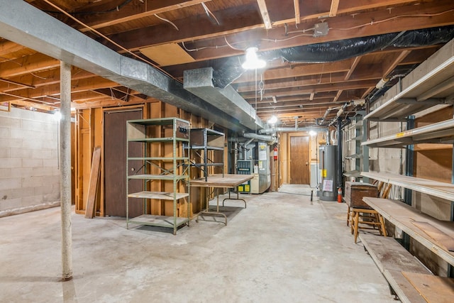 unfinished basement with water heater and heating unit