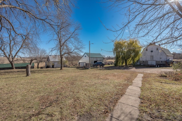 view of yard with an outbuilding and a barn