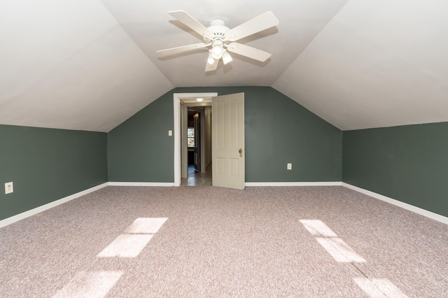 additional living space with lofted ceiling, a ceiling fan, baseboards, and carpet flooring